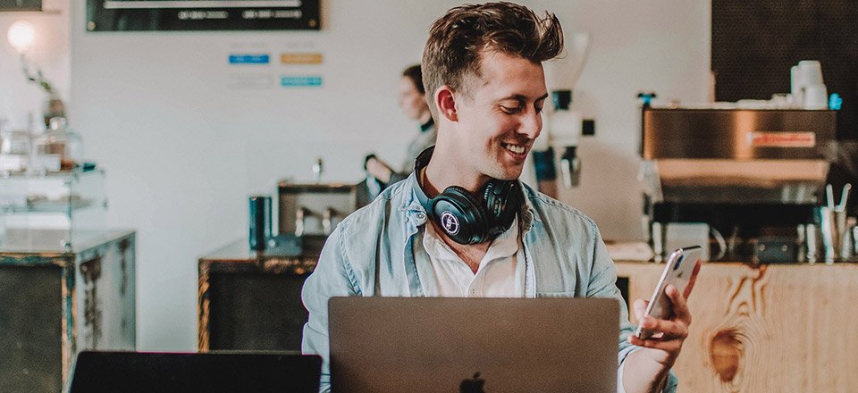 Young man working on computer and mobile